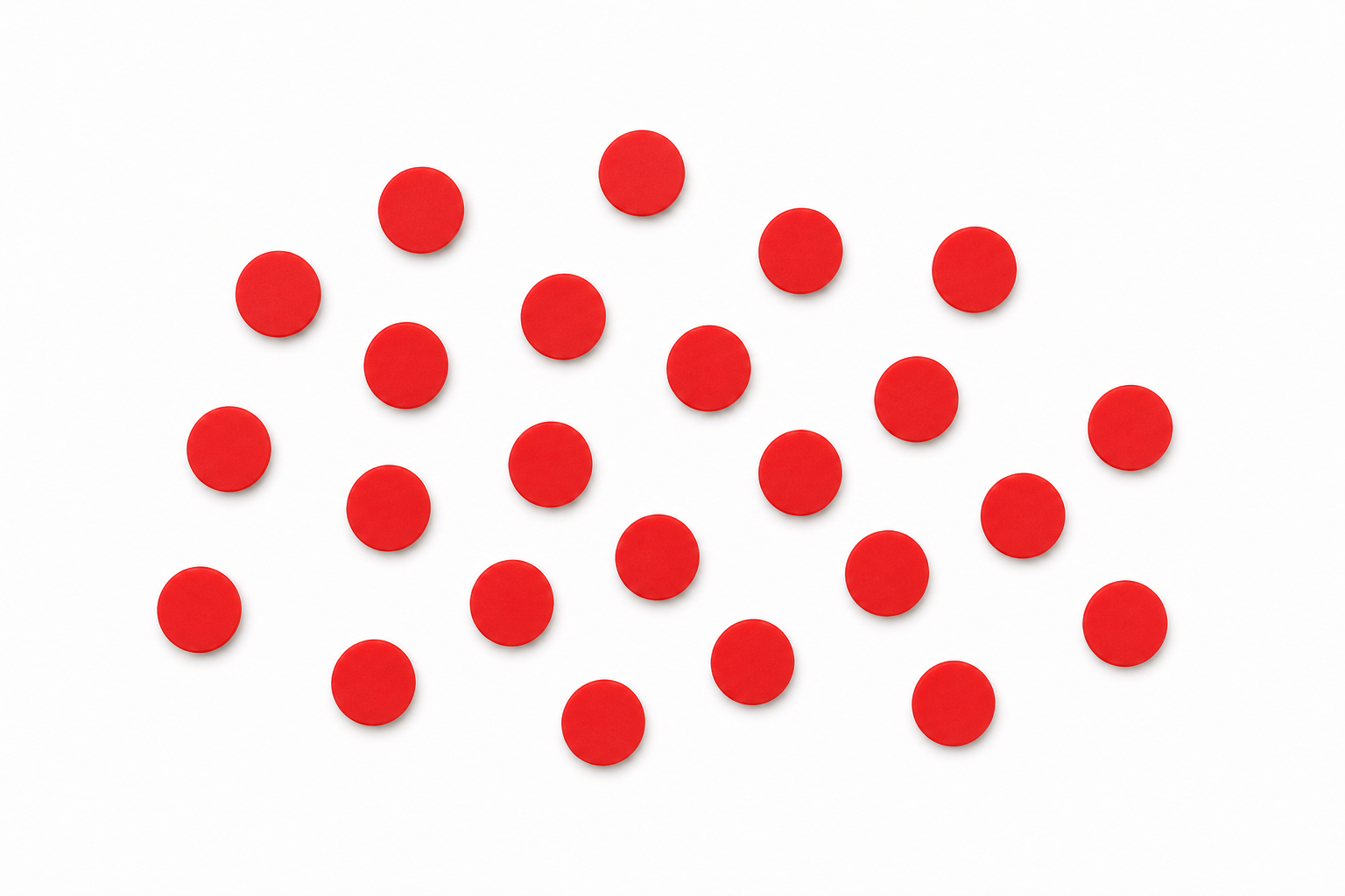 Twenty-four identical small round flat counters in a single bright colour, scattered loosely in a rough group on a plain background, all the same size, viewed straight on from above, not arranged into rows or piles