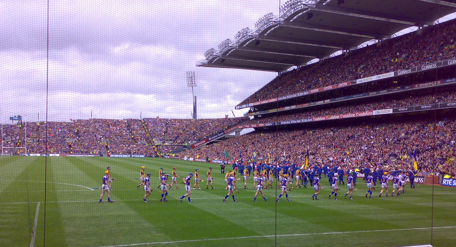 A wide view of Croke Park: the stands, the crowd and the two teams parading on the pitch before the 2009 All-Ireland hurling final