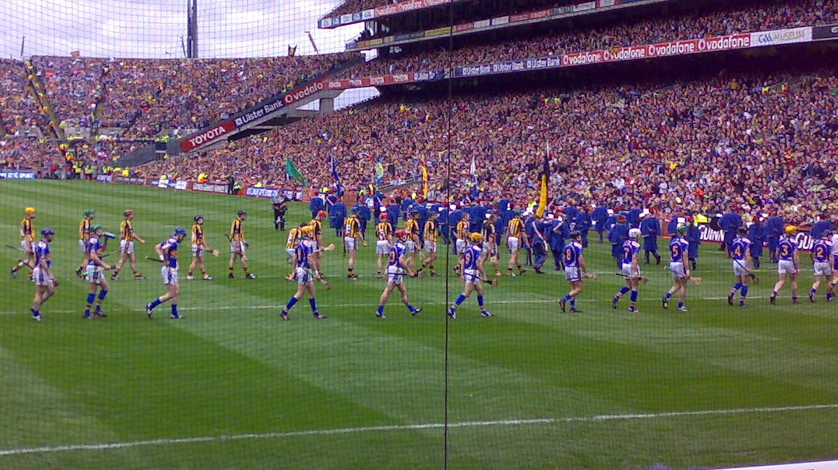 The same photo, cropped close on the teams parading