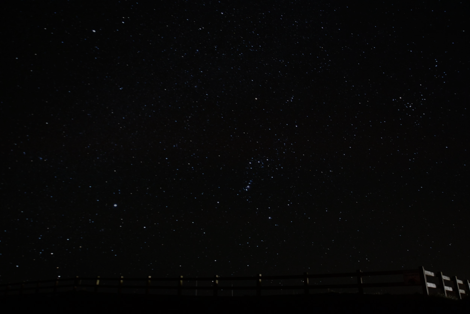 A night sky photo so dark that only a few stars show